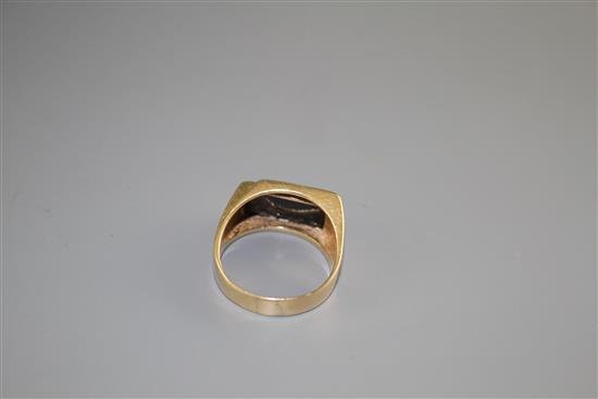 A 14k yellow metal, diamond and black onyx set dress ring, size U/V, gross weight 8.4 grams.